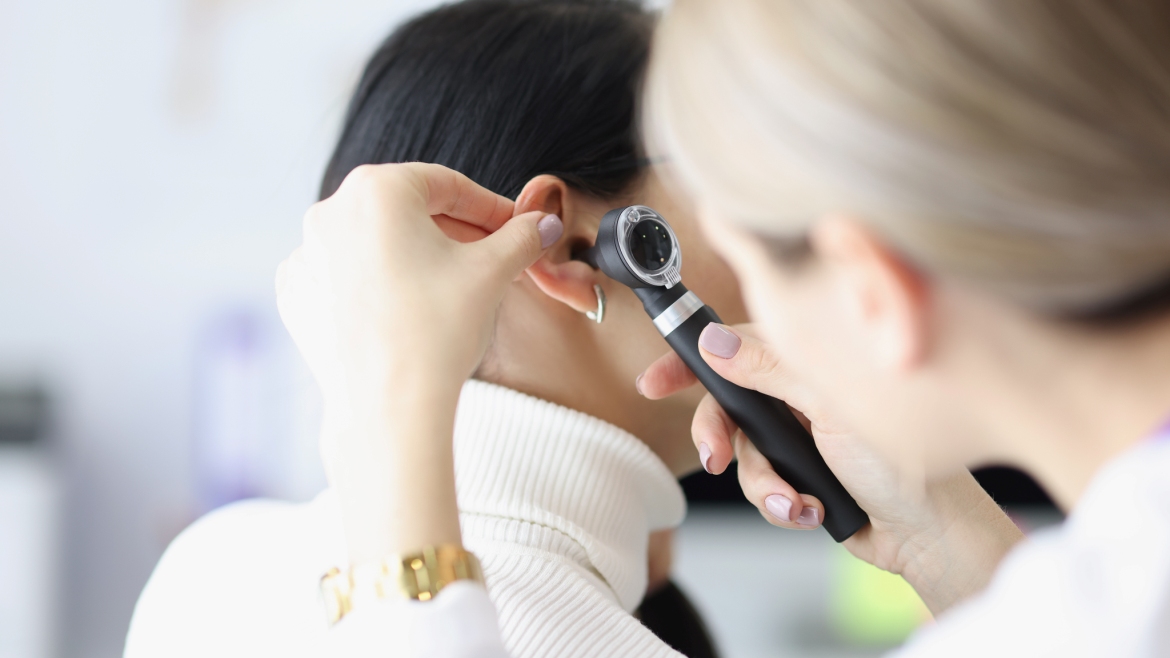 closeup-female-otolaryngologist-examining-ear-with.jpg